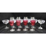 A SET OF SIX CHAMPAGNE SAUCERS, etched rims and stars to the body, together with a set of four