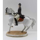 A 20TH CENTURY VIENNA PORCELAIN EQUESTRIAN FIGURE, a rider from the Spanish Riding School, gilded