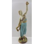 A ROYAL WORCESTER CERAMIC FIGURE, depicting a classically robed woman holding a bird aloft in her