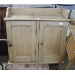 A SMALL PINE HANGING TWO DOOR CUPBOARD