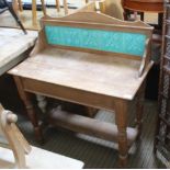 AN EARLY 20TH CENTURY PINE FRAMED WASHSTAND having turquoise tiled splash back, a rectangular top on