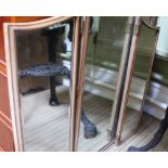 A GILT OVAL WALL MIRROR together with a triple plate dressing table top mirror