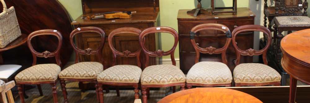 A SET OF SIX MAHOGANY FINISHED BALLOON BACK CHAIRS with upholstered serpentine fronted seat pads