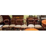 A SET OF SIX MAHOGANY FINISHED BALLOON BACK CHAIRS with upholstered serpentine fronted seat pads