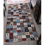 A MODERN HAND WOVEN PAKISTANI WOOLLEN LONG RUG, in a patchwork design, 203cm x 90cm