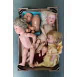A BOX CONTAINING A SELECTION OF DOLLS AND DOLL PARTS