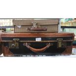 A VINTAGE LEATHER BOUND SUITCASE together with a mid-century smaller case