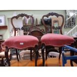 A PAIR OF PROBABLE FRENCH MAHOGANY FINISHED SALON CHAIRS with fancy carved crest rail and pierced