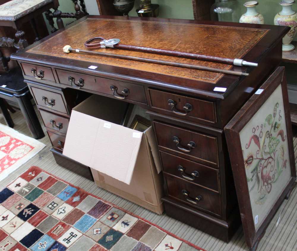 A REPRODUCTION MAHOGANY FINISHED TWIN PEDESTAL DESK, of typical form and construction, with well