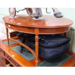 A REPRODUCTION YEW WOOD FINISHED OVAL TOPPED COFFEE TABLE on four carved leaf and reeded legs,