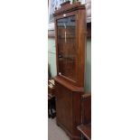 A REPRODUCTION, LIGHT MAHOGANY COLOURED CORNER CUPBOARD, with glazed upper section and solid door