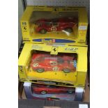 A BOX CONTAINING FOUR BOXED FERRARI SPORTS CARS together with a selection of Ferrari related