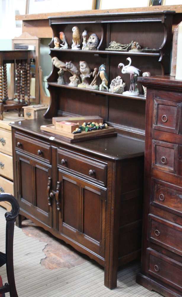 AN ERCOL BRANDED KITCHEN DRESSER with low twin shelf plate rack back, over two inline drawers &