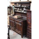 AN ERCOL BRANDED KITCHEN DRESSER with low twin shelf plate rack back, over two inline drawers &