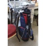 A MODERN GOLF BAG CONTAINING A SMALL SELECTION OF CLUBS VARIOUS