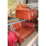 A TAN UPHOLSTERED TWO PIECE SUITE comprising settee and single deep seated armchair
