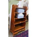 A WOODEN SET OF OPEN FRONT WATERFALL STYLE SHELVES with two inline drawers to the base