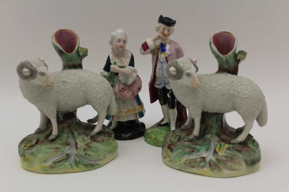 TWO 19TH CENTURY STAFFORDSHIRE POTTERY SHEEP SPILL HOLDERS, 13.5cm high, together with a pair of