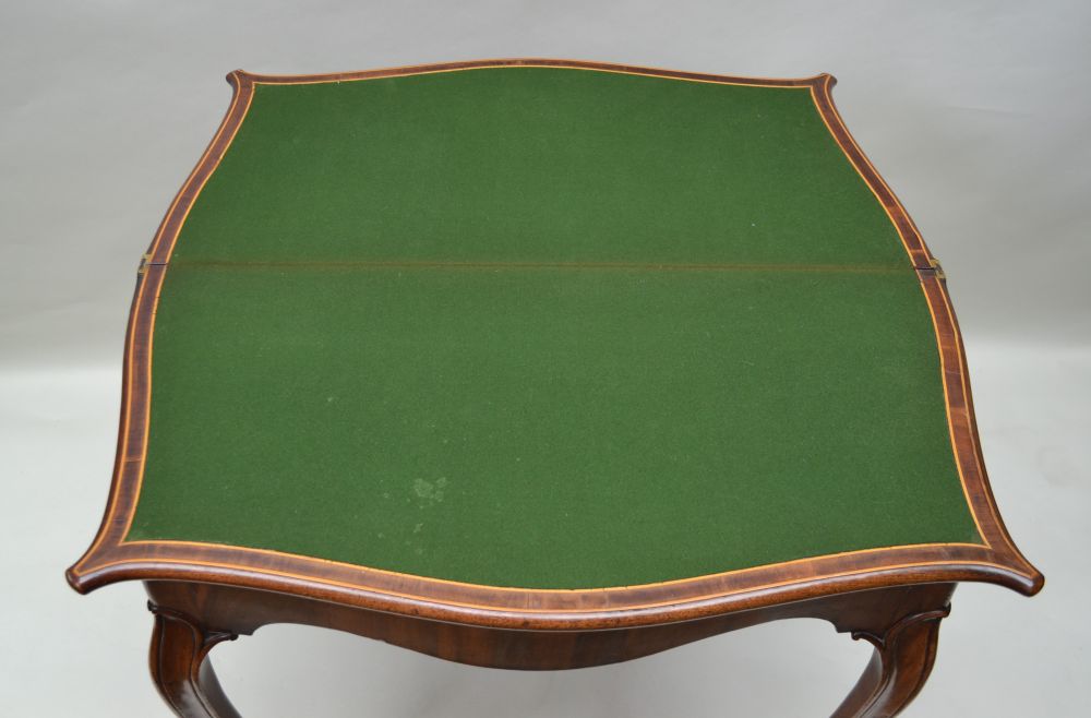 A 19TH CENTURY FRENCH FOLD OVER CARD TABLE, serpentine crossbanded with string inlay, green baize