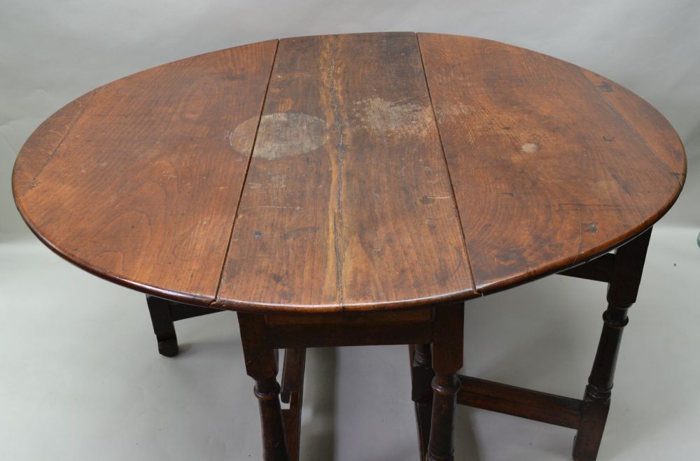 AN 18TH CENTURY OAK TWIN FLAP GATELEG DINING TABLE of oval form with opposing cutlery drawers, - Image 2 of 3