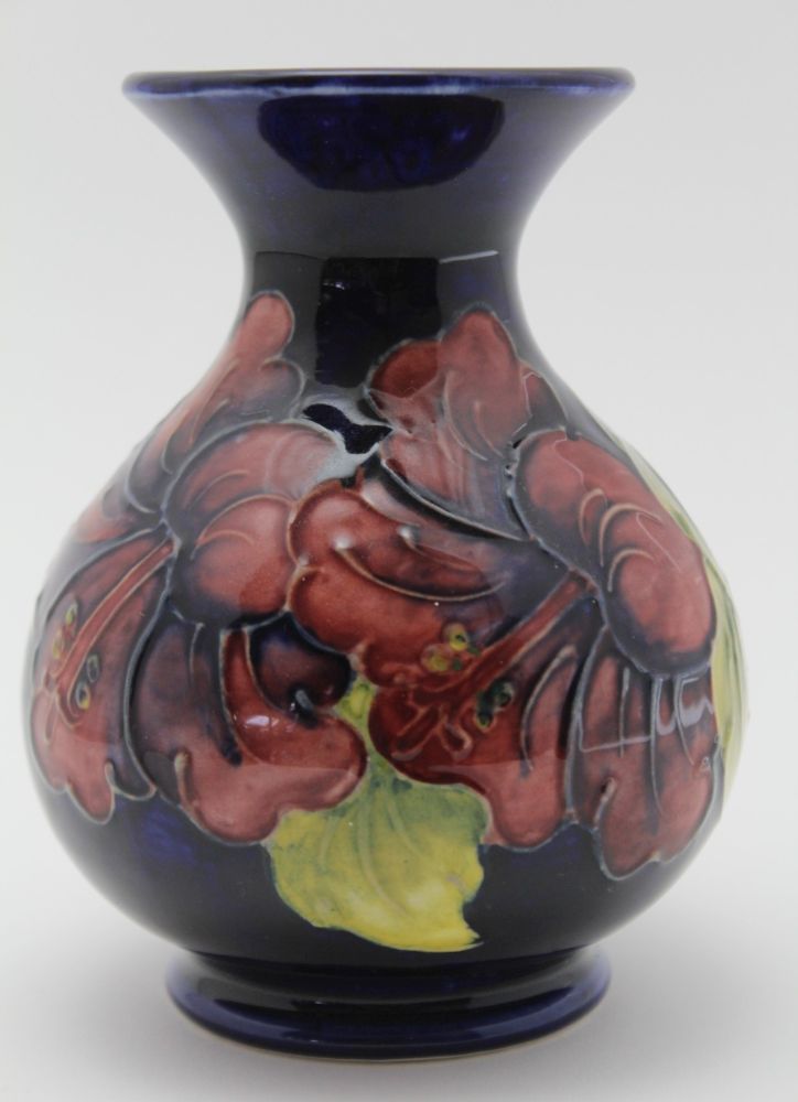 A MOORCROFT POTTERY VASE, tube lined and painted Hibiscus patten and a painted and impressed factory