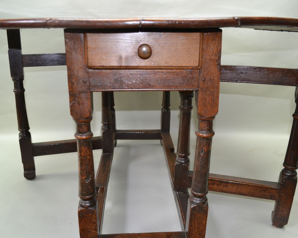 AN 18TH CENTURY OAK TWIN FLAP GATELEG DINING TABLE of oval form with opposing cutlery drawers, - Image 3 of 3