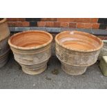 A NEAR PAIR OF TERACOTTA HAND THROWN PLANTERS