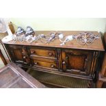 A REPRODUCTION OAK FINISHING SIDEBOARD UNIT, having rectangular top, two central drawers, flanked by