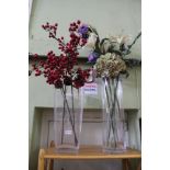 TWO OVERSIZED GLASS VASES containing everlasting flowers