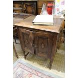 AN OAK TWO DOOR SIDE CABINET on short barley twist & block legs