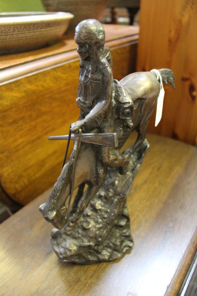 A CAST METAL MODEL OF A NATIVE AMERICAN INDIAN upon his horse, similar in design to the figures by