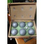 A WOODEN CASED SET OF FRENCH BOULES