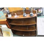 AN OPEN FRONTED SET OF BOWED SHELVES