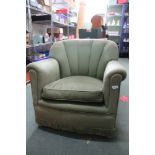 A JADE GREEN UPHOLSTERED LOW SCALLOPED BACK ARMCHAIR