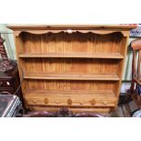 A WALL HANGING SET OF PINE STORAGE SHELVES with four inline spice drawers