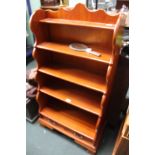 A WOODEN SET OF OPEN FRONT WATERFALL STYLE SHELVES with two inline drawers to the base