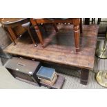 AN IMPORTED HARDWOOD RECTANGULAR PLANK TOPPED COFFEE TABLE on short stubby block legs, with