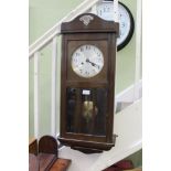 A 20TH CENTURY OAK CASED VIENESSE STYLE HANGING WALL CLOCK with display pendulum