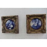 A PAIR OF FANCY FRAMED BLUE & WHITE CERAMIC ROUNDELS depicting children playing in the woods