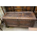 A PROBABLE PART LATE 18TH CENTURY OAK COFFER having triple panel lift up lid, later carved twin