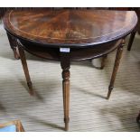 A REPRODUCTION MAHOGANY FINISHED DEMILUNE TABLE with storage undertier, on three legs