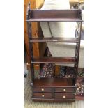 A REPRODUCTION MAHOGANY FINISHED SET OF HANGING SHELVES with pierced plank side supports, having a