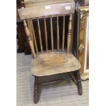 A 19TH CENTURY SPINDLE BACKED SOLID ELM SEATED CHILD SIZED CHAIR