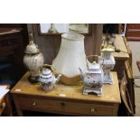TWO ORIENTAL DESIGN TABLE LIGHTS with tasselled shades, together with two white glazed decorated