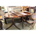 A REPRODUCTION MAHOGANY OVAL TOPPED DINING TABLE on twin turned pedestal, with single extra leaf