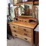 AN EARLY 20TH CENTURY DRESSING CHEST having adjustable mirrored back, over display shelf and twin