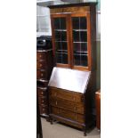 A MAHOGANY FINISHED BUREAU BOOKCASE with twin leaded glass doors, with adjustable shelved interior