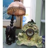 A WOODEN ELEPHANT TABLE LAMP and a green porcelain mantel clock