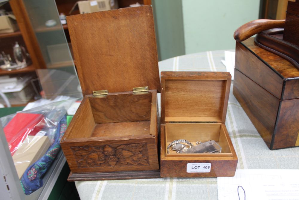 A CARVED OAK BOX, decorated with acorns, together with a small wooden box, containing a coin