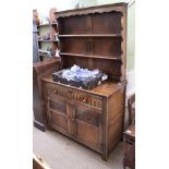 A SMALL PROPORTIONED REPRODUCTION OAK DRESSER, with twin shelved plate rack back